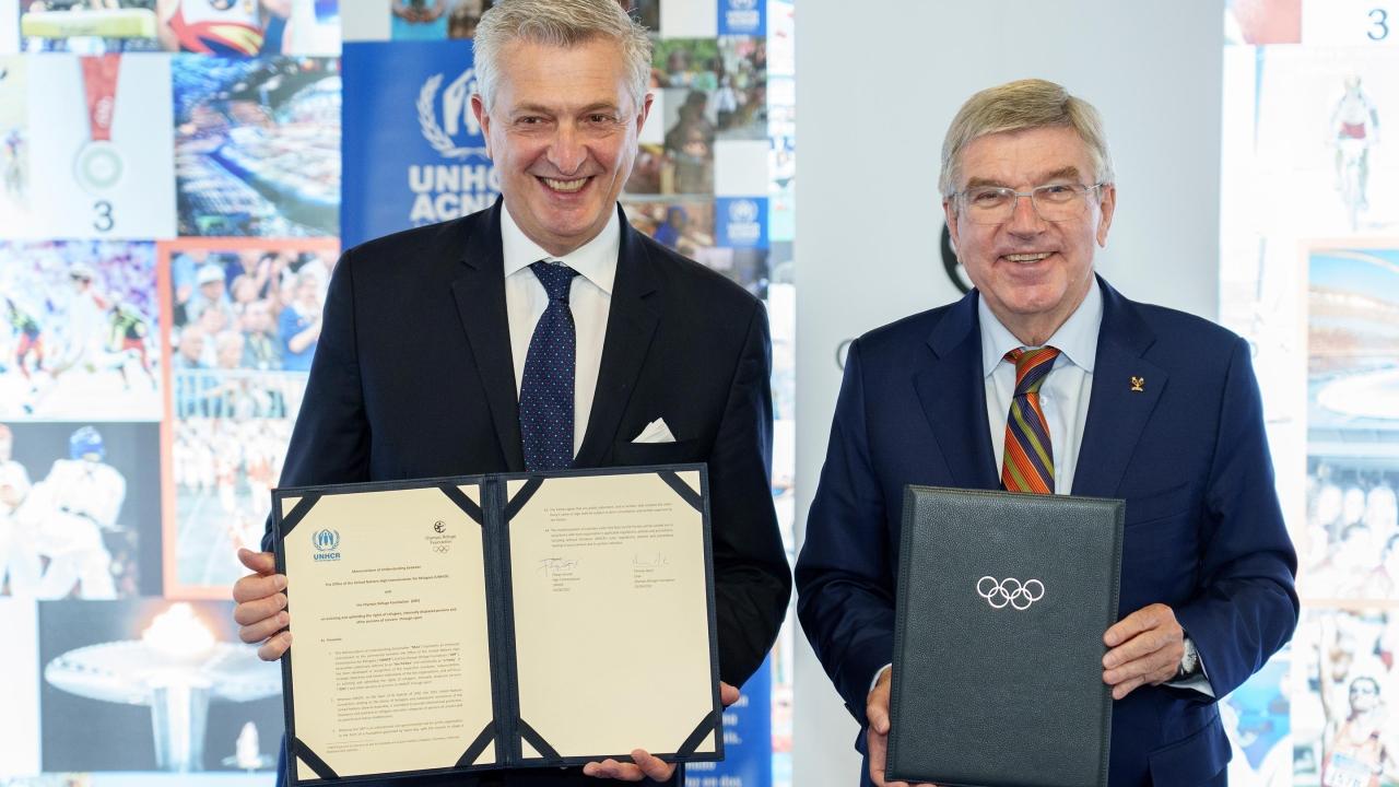 two people holding official signed documents