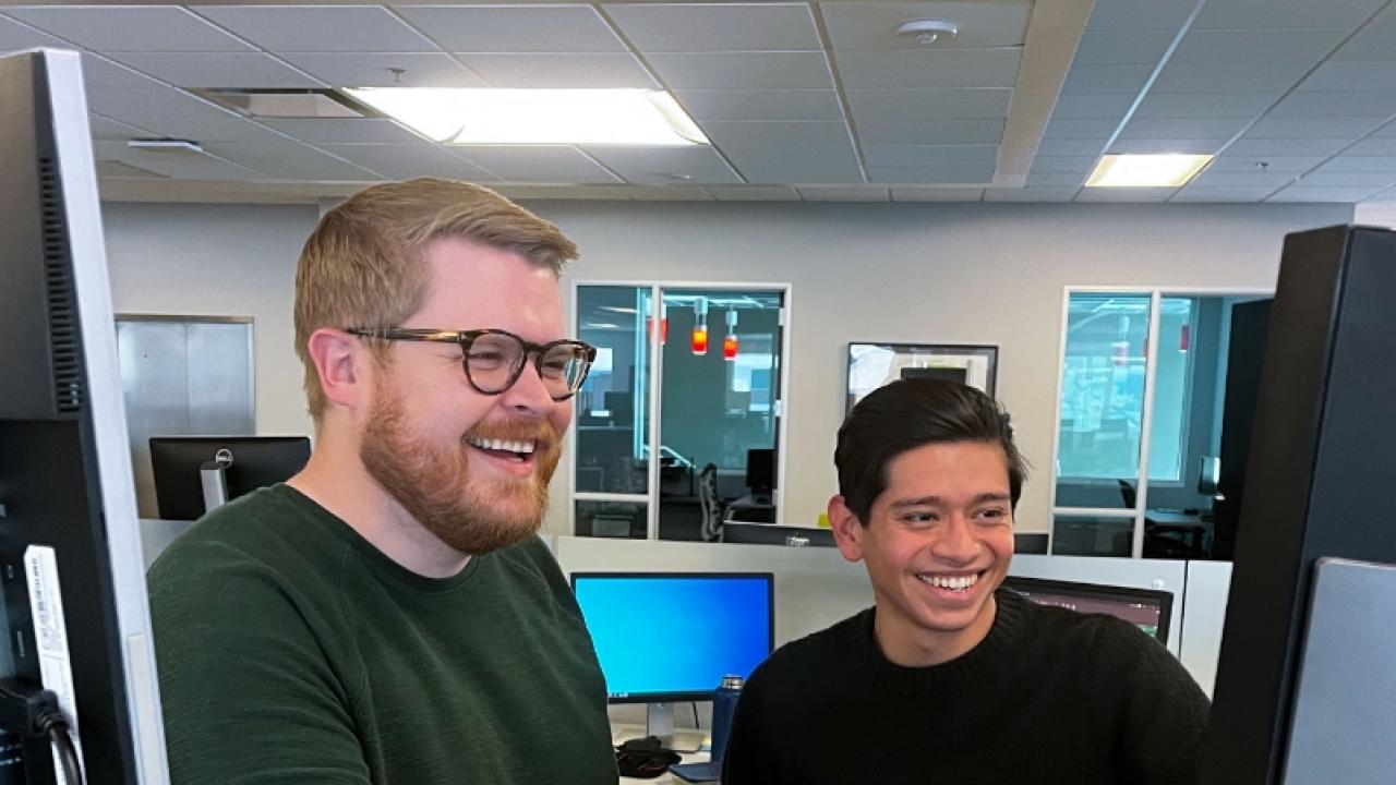two people working together in office