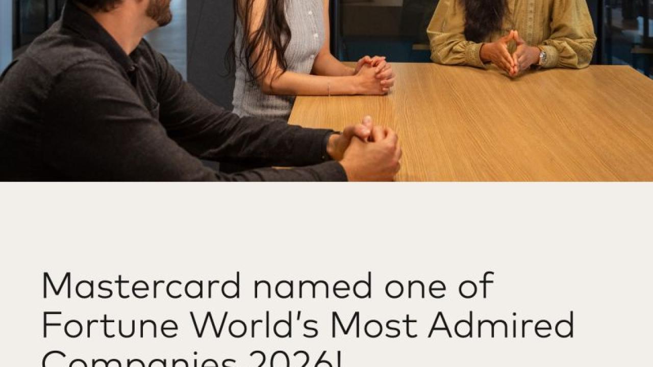 Three people sitting at table talking