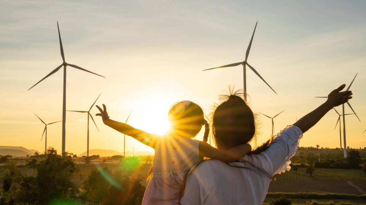 Parent and child looking windfarm