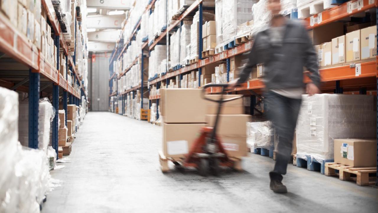 Worker pulling boxes in a warehouse