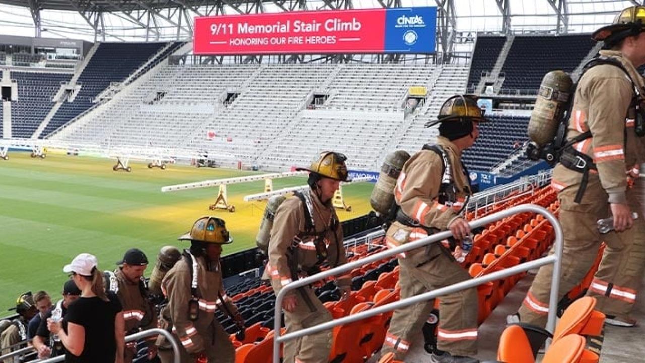 firefighters climbing stairs in a stadium 