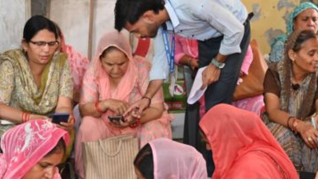 Group of Indian women looking at their phones