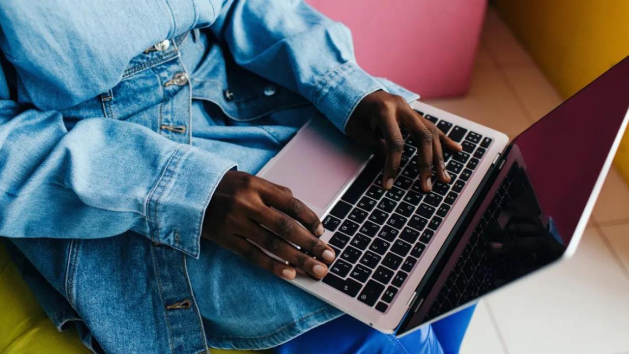 A person typing on a laptop.