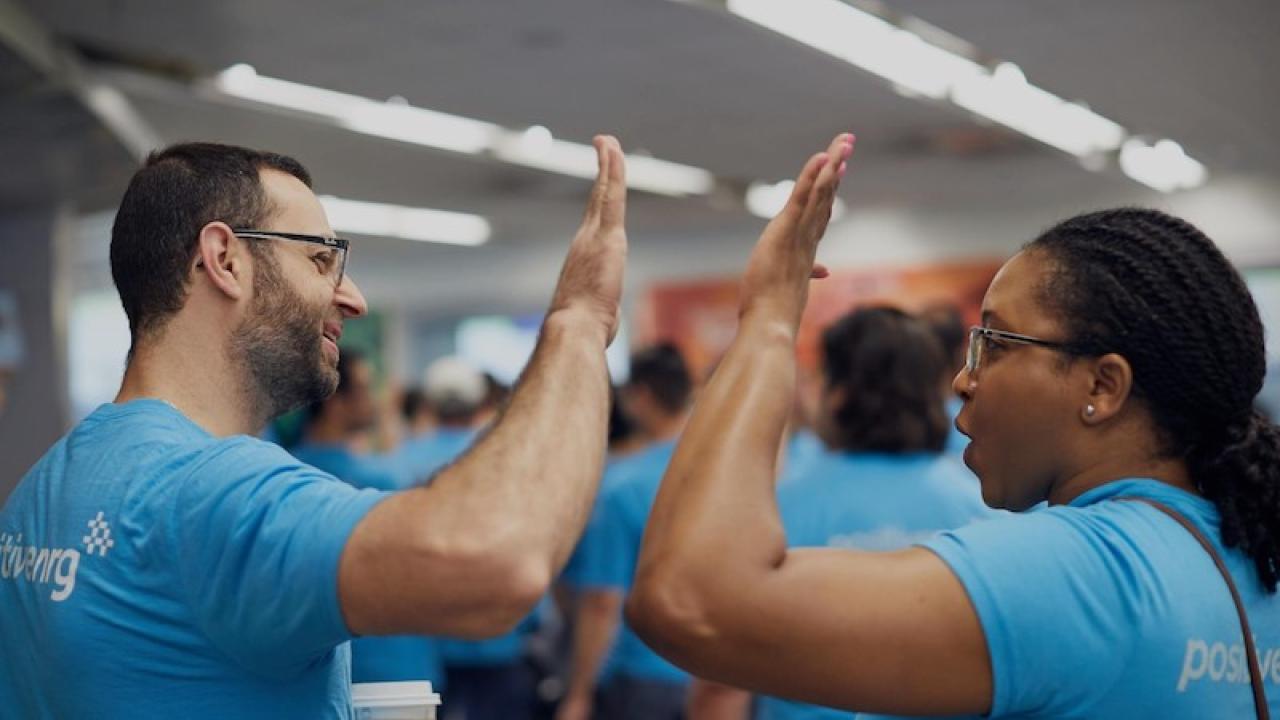 NRG Energy employees giving a high five.