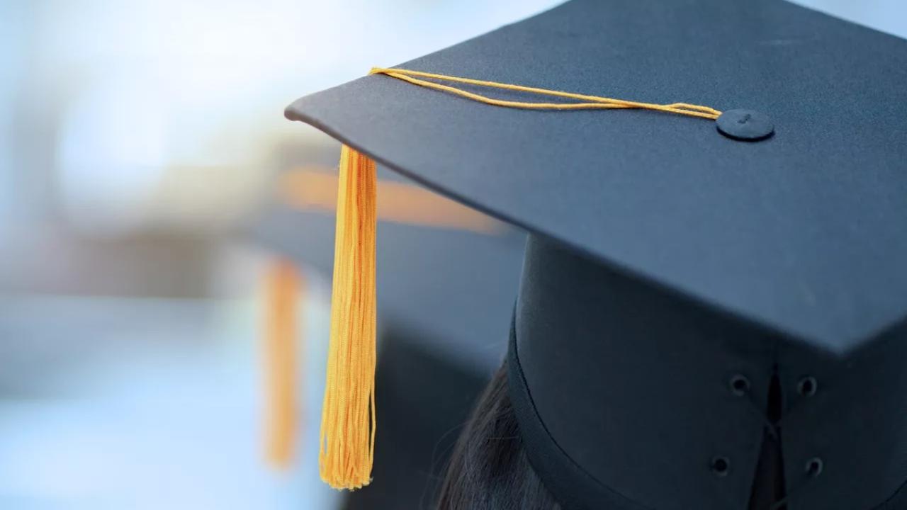 Graduates mitre shown with gold tassel.