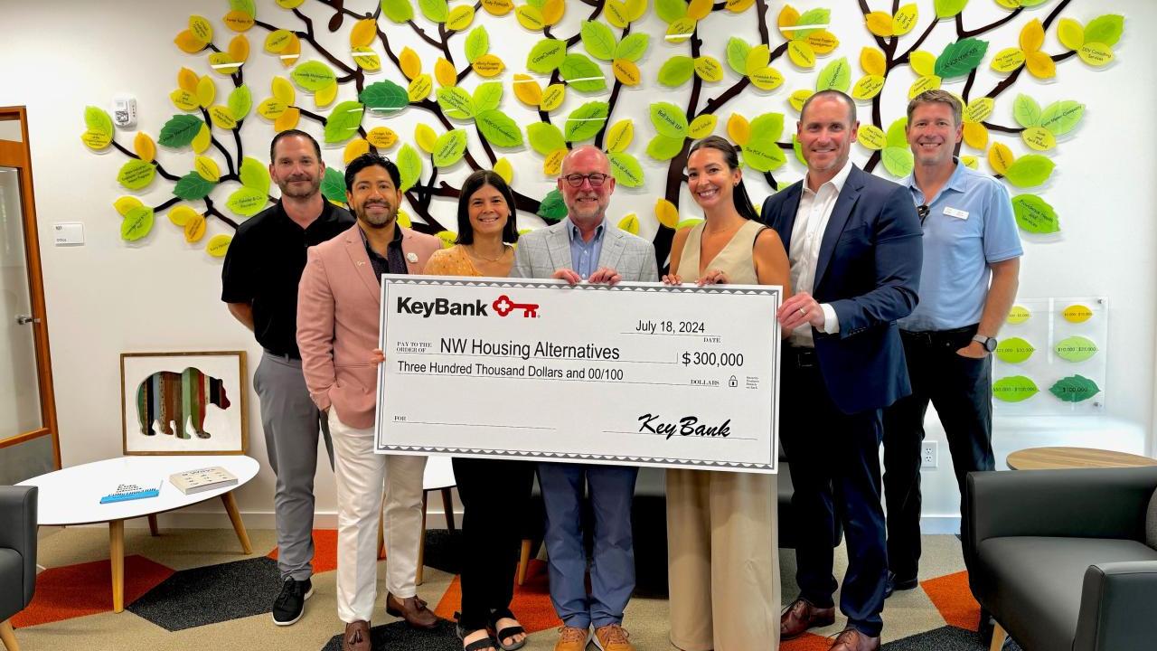 A group of people holding a large cheque 