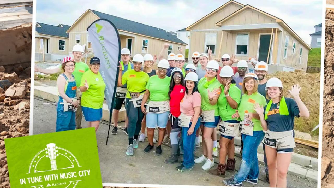 A group of volunteers posed outside a home being built.