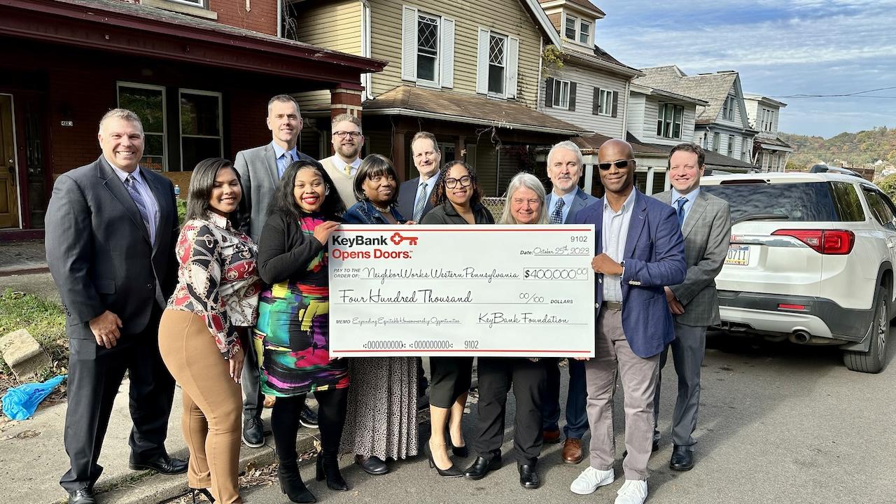 KeyBank and NeighborWorks Team shown with a check for $400,000.