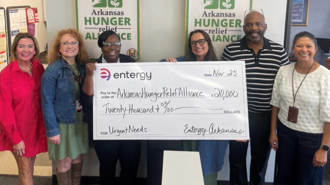 Group photo of people holding up check for Arkansa's Hunger Relief Alliance