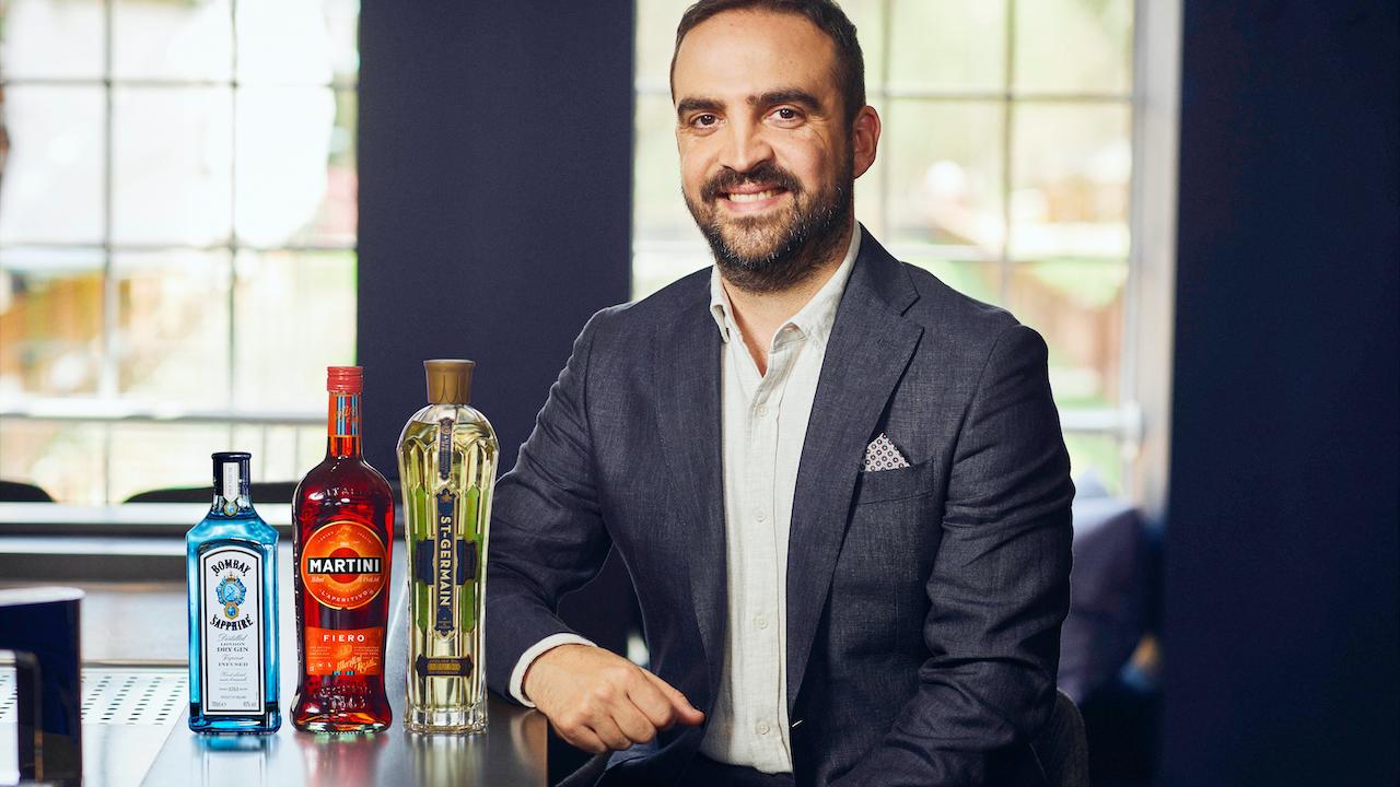 Headshot of Alessandro Garneri next to Bombay Sapphire, Martini, and ST-GERMAIN bottles