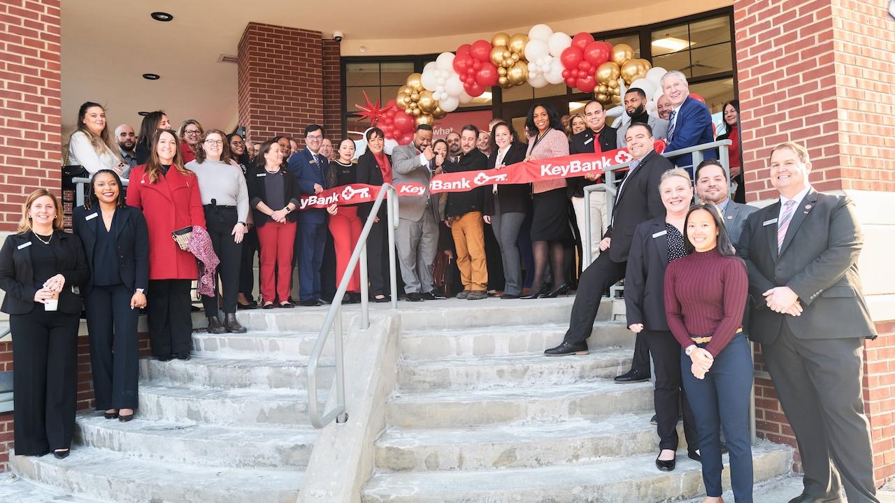 KeyBank Branch Manager Jeffrey Almanzar (center with scissors) cuts the ribbon on the bank’s newest branch at 1 Main Street Port Chester, NY at a ribbon-cutting ceremony held January 29, 2025.