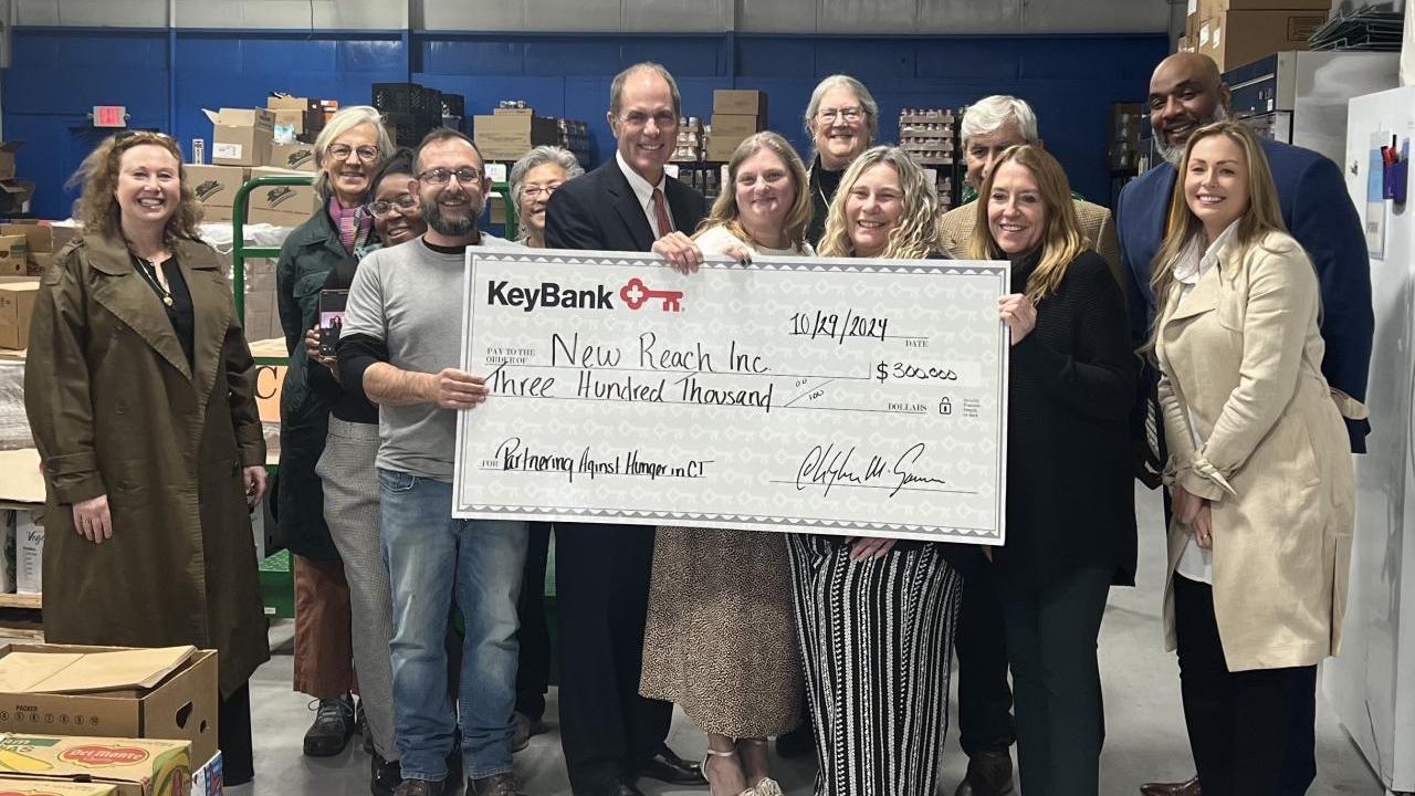 New Reach and KeyBank team shown with grant check.