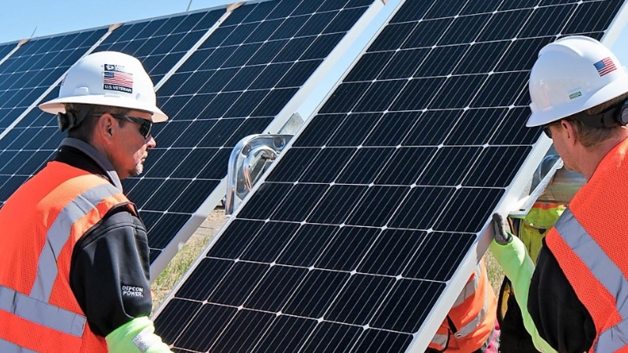 workers near a solar panel