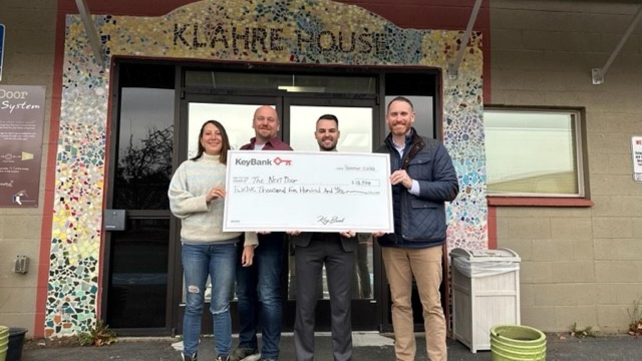 KeyBank and The Next Door Team shown with Grant Check.