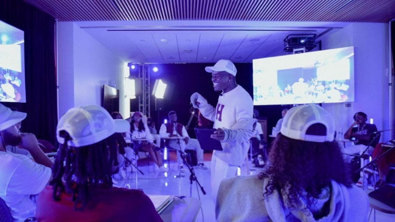 Group of people watching No Label Academy presentation
