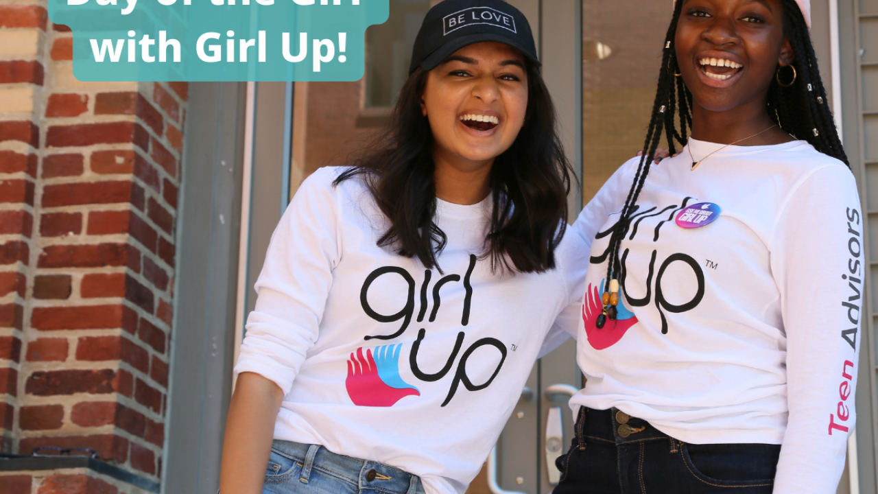 Two people on a front porch, both wearing "girl up" t-shirts.