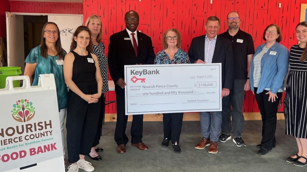 Grant check presentation between the Nourish Pierce County Food Bank and KeyBank.