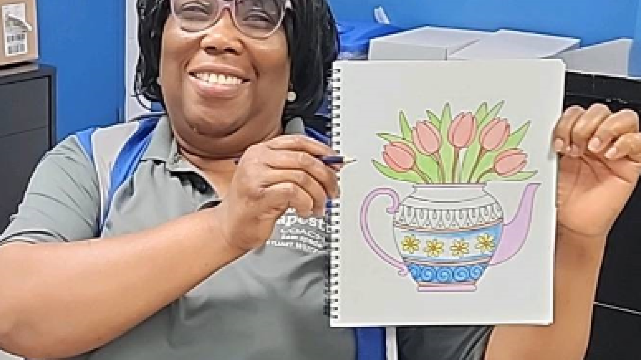 A woman coloring at Tapestry's Ohio fulfillment center