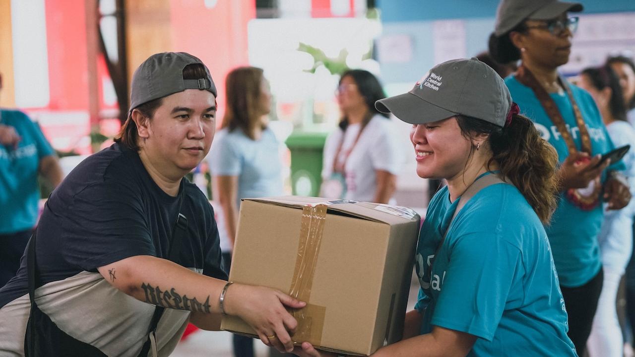 In Manila, Philippines, Principal employees put the finishing touches on packaged meals to be donated locally.