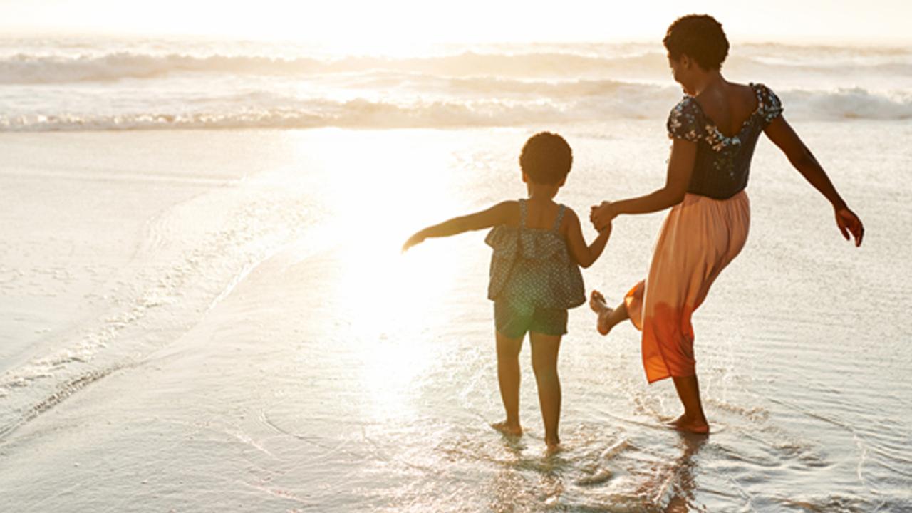 mother and child wading at the beach