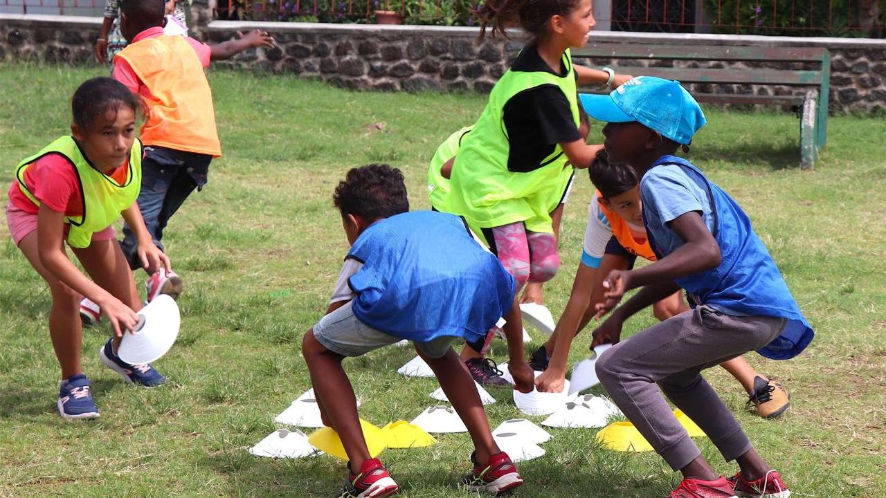 Young children playing sport outdoors