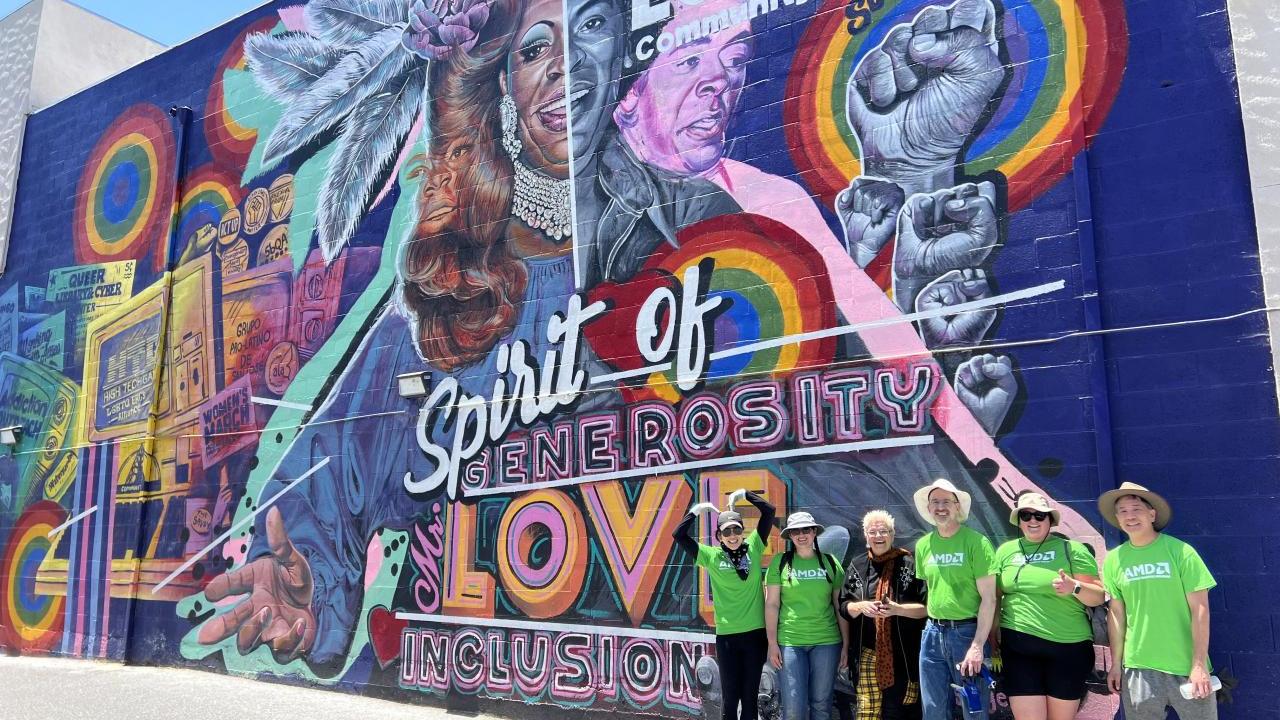 Group poses in front of LGBTQ+ Mural 