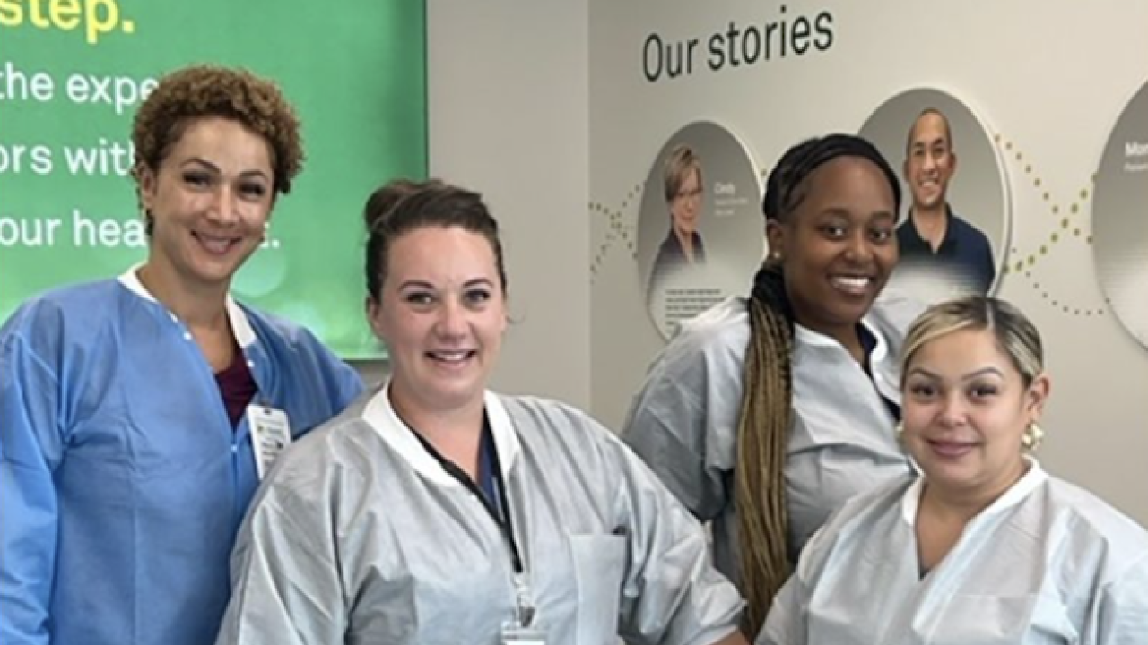 Four healthcare professionals stood together smiling 