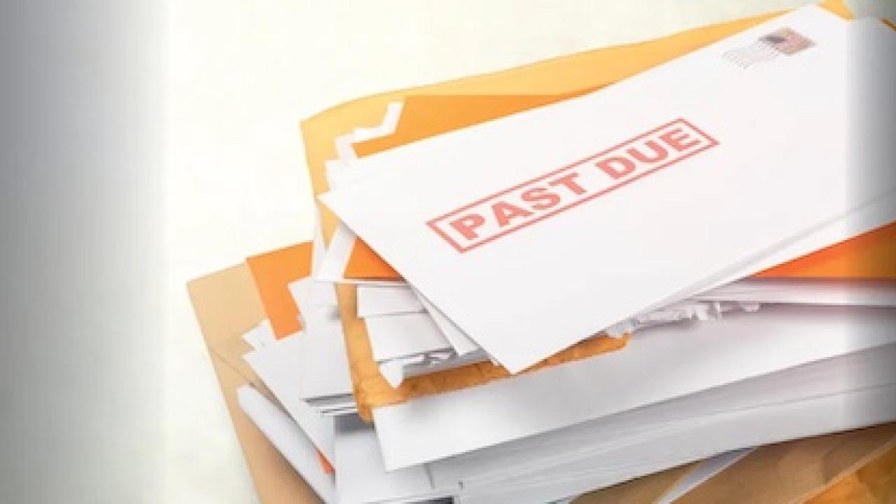 Stack of bills with past due stamped on the front.