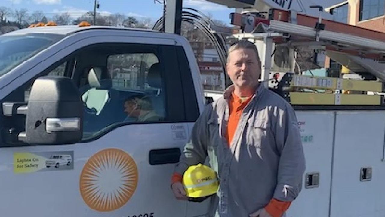 Photo of Don Brett standing in front of his PSEG truck.