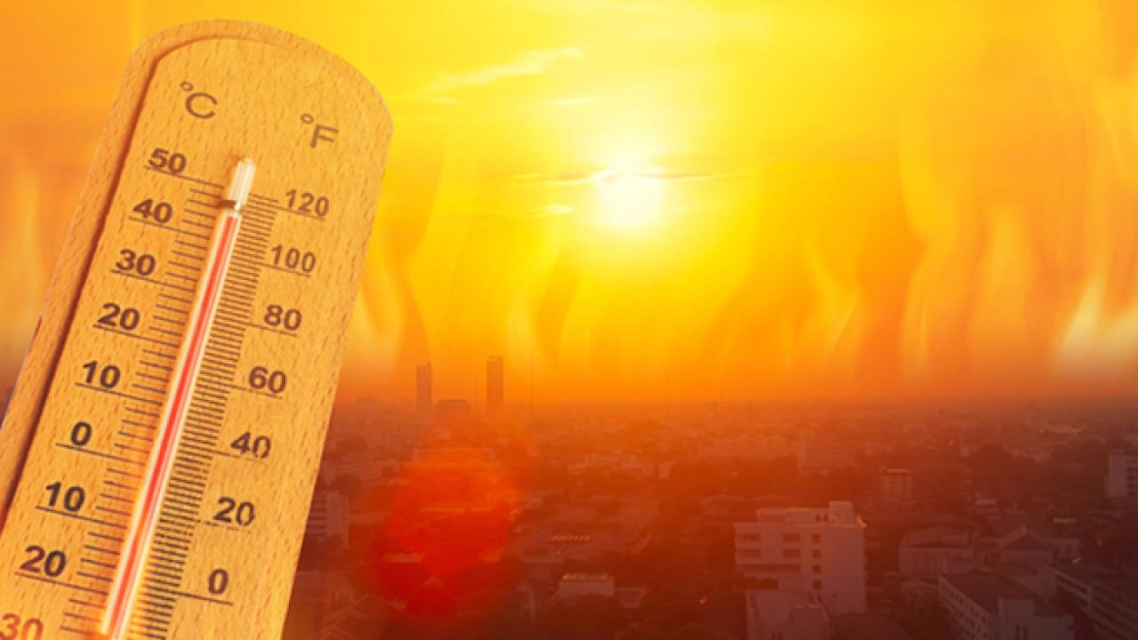Thermometer shown against a blazing red sun.
