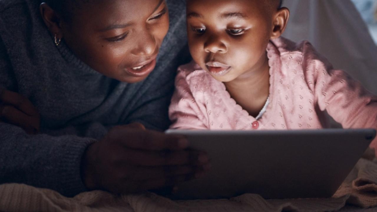 Mother and daughter looking at computer screen.