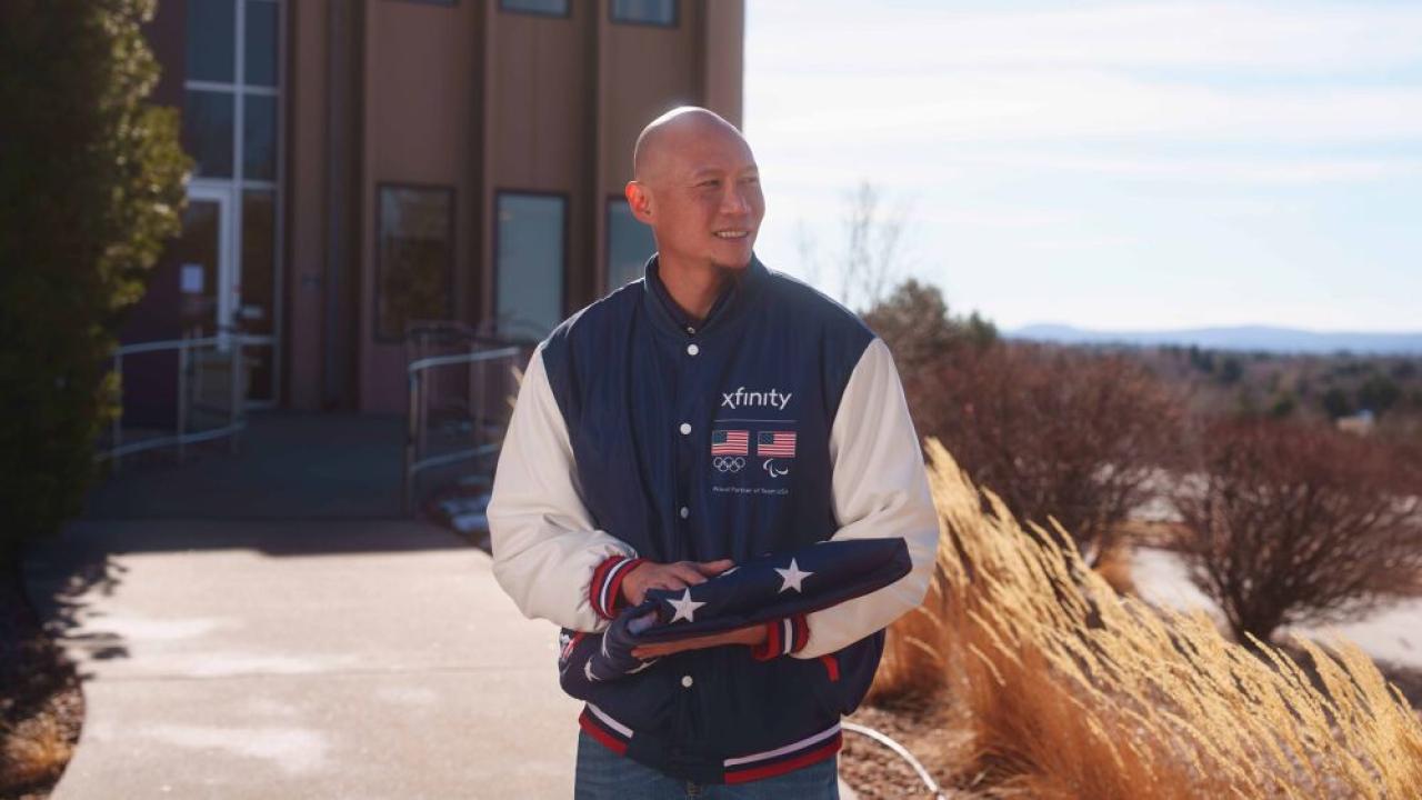 U.S. Paralympic Gold Medalist Jen Lee holding folded up American flag