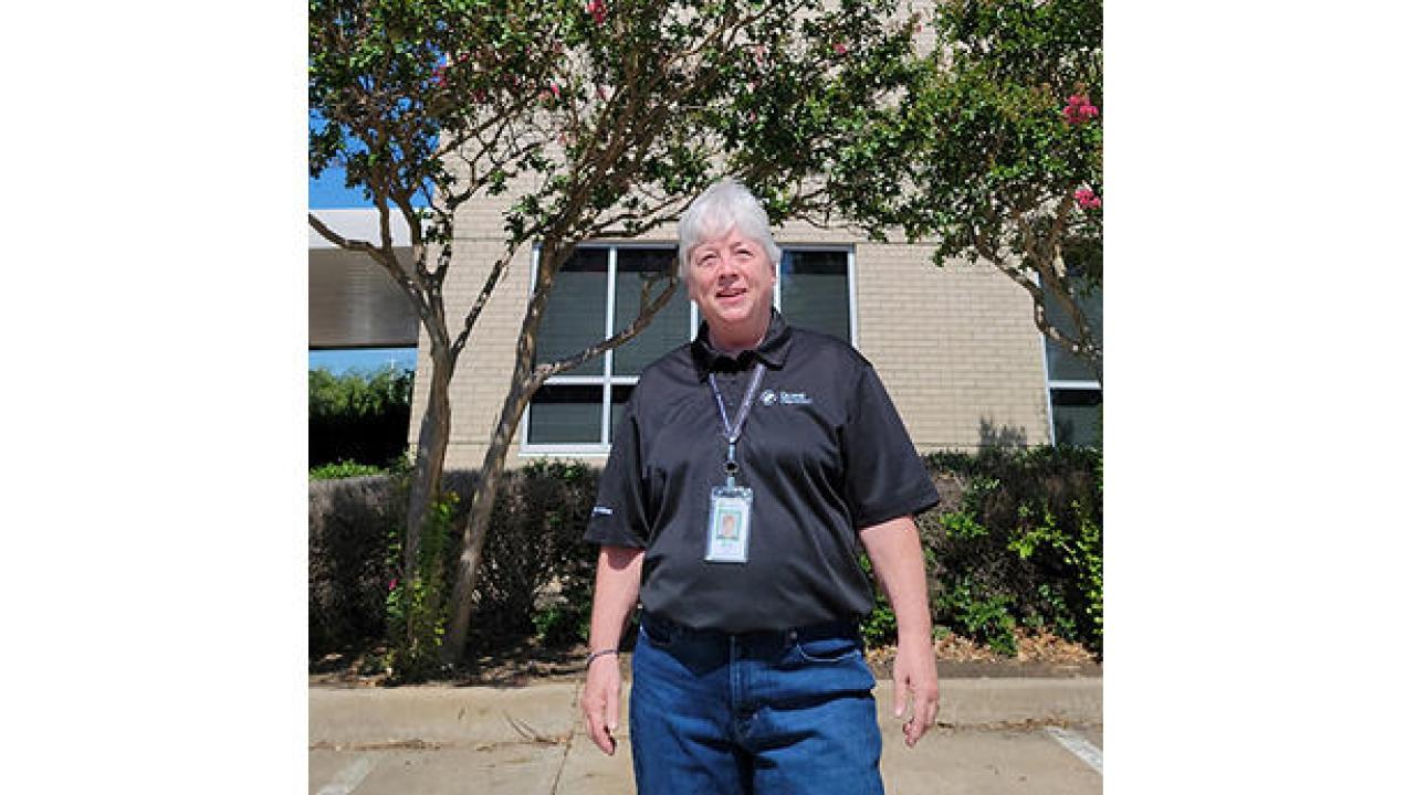 Pat Beall stood in front of a building 