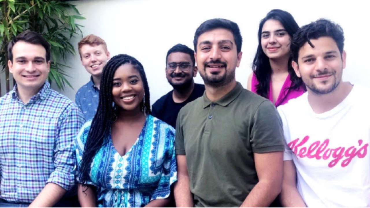 7 people pose for a photo
