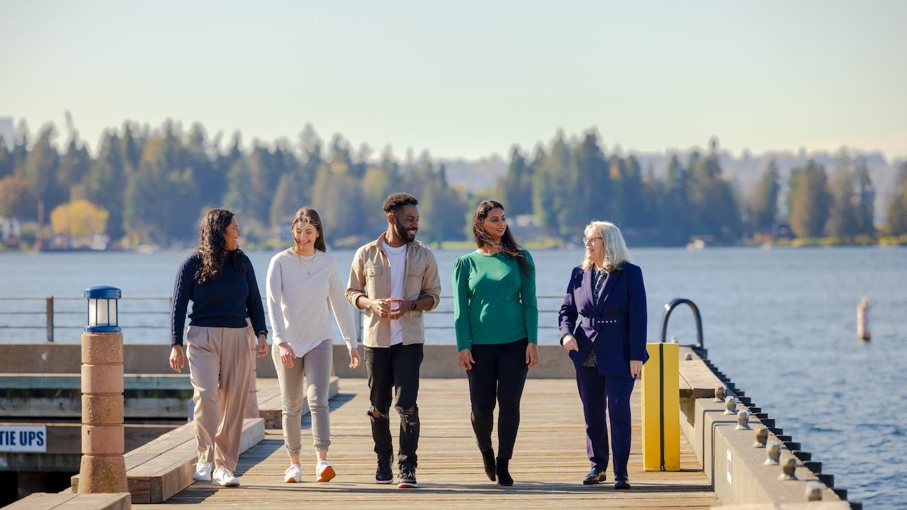 Group of GoDaddy employees walking along a pier.