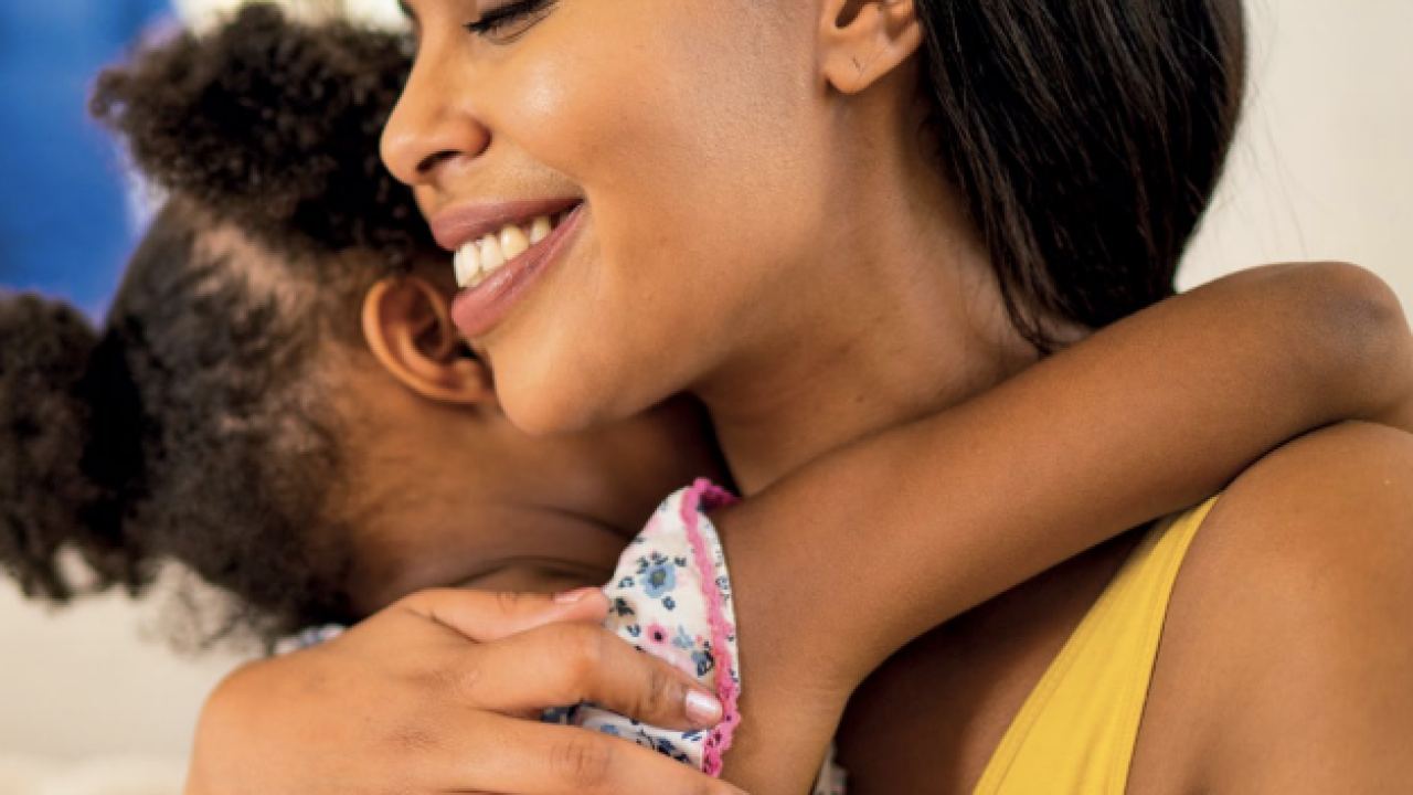 An adult and child hugging 