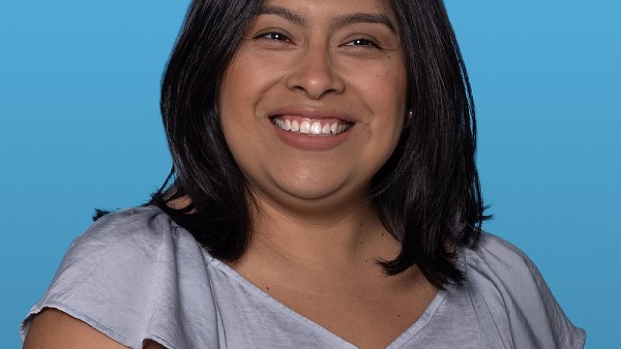 Headshot of Janet Perez against a blue background