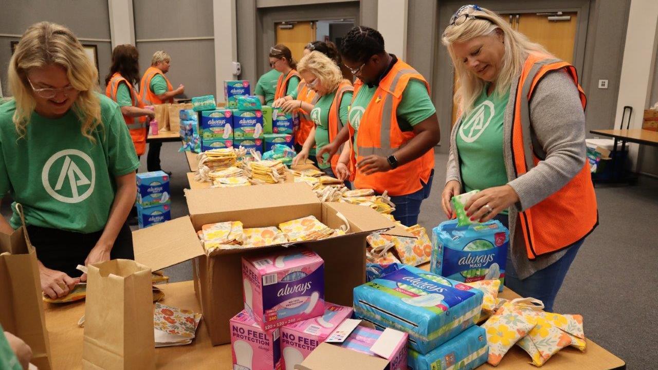 Women packaging menstrual health management supplies 