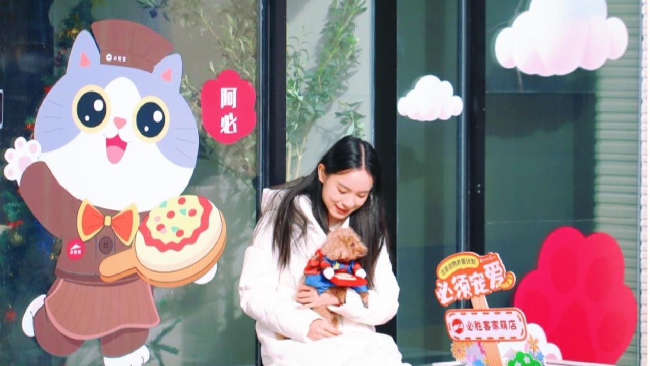Person sat holding a dog on their lap outside a pet-friendly restaurant 