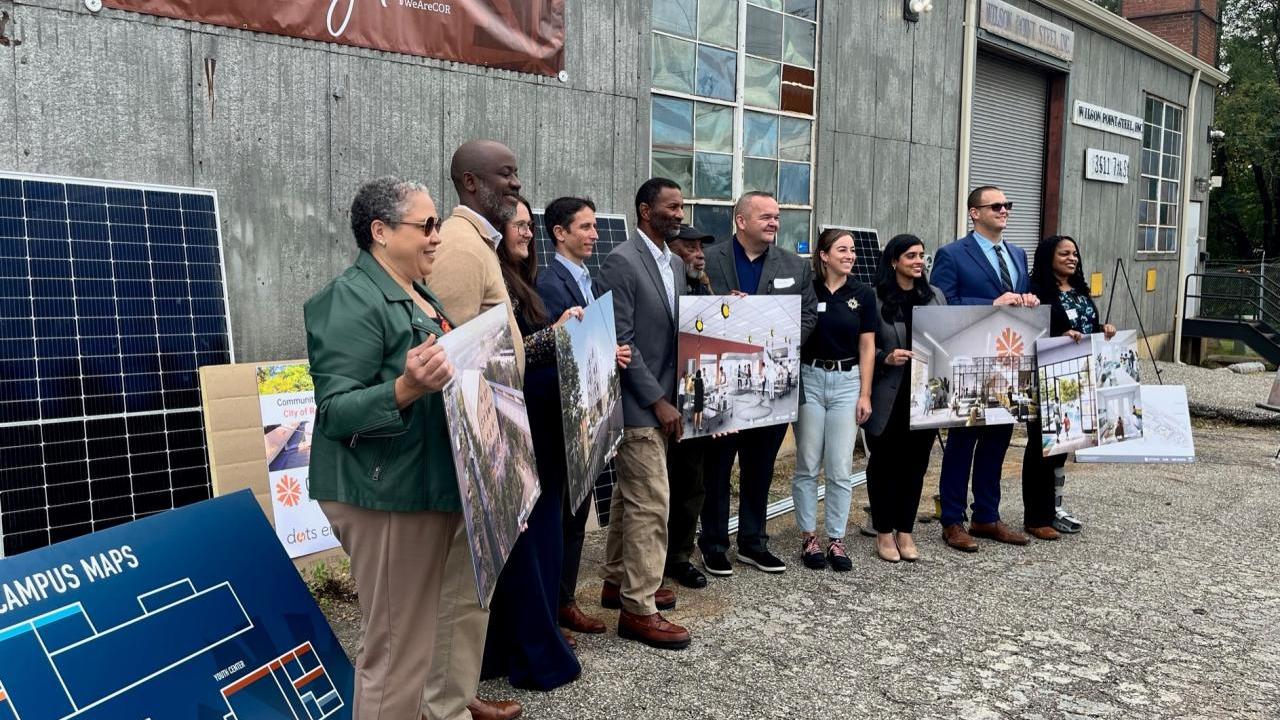 Baltimore City Community Resiliency Hub project participants with images of future plans
