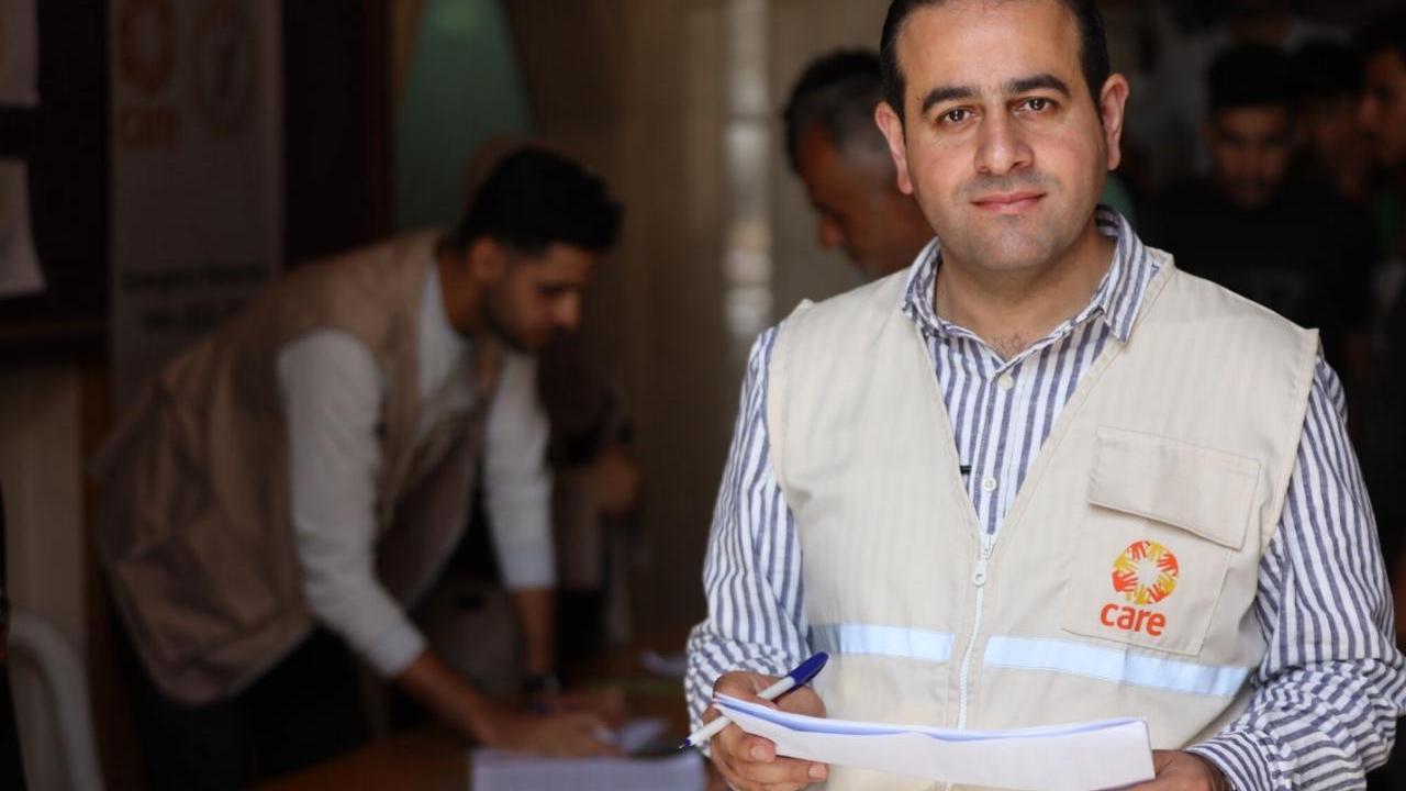 A man in an aid worker vest. 