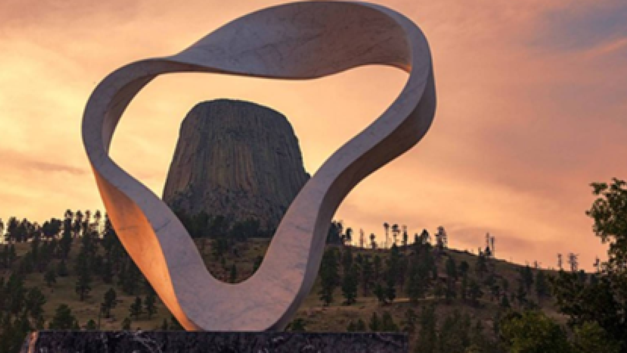 Sculpture with Devil's Tower behind it