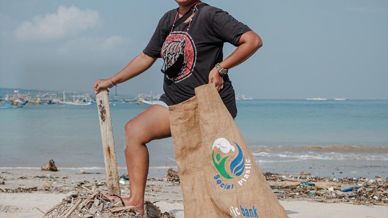 Woman with a bag of trash cleaned from the beach