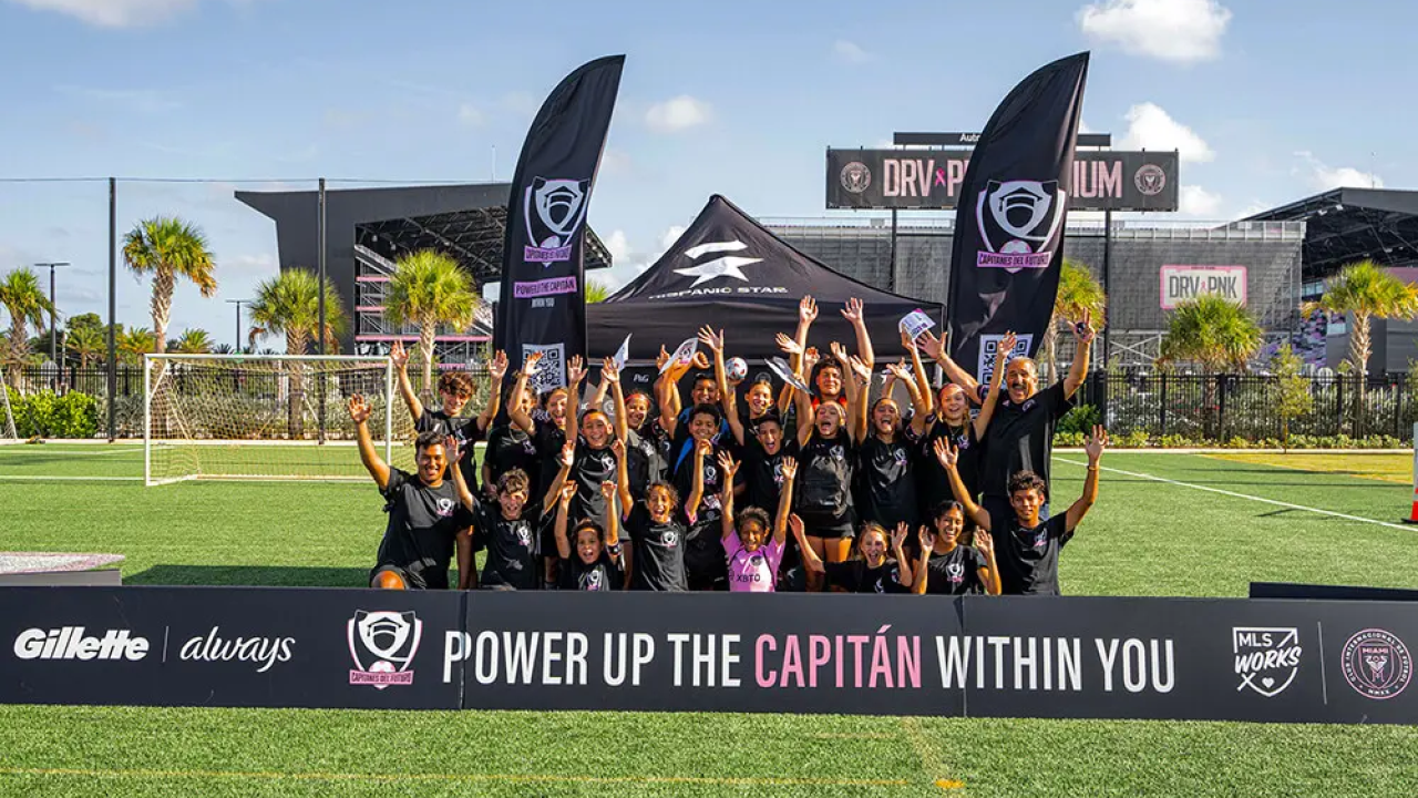 Group of young girls with sign that says "Power up the Capitan within you