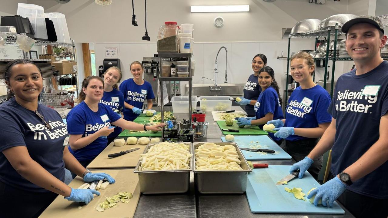 Volunteers cut food in the kitchen