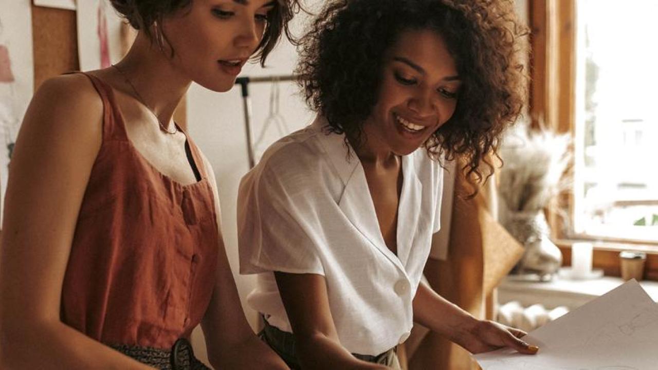 Two women working on a presentation.