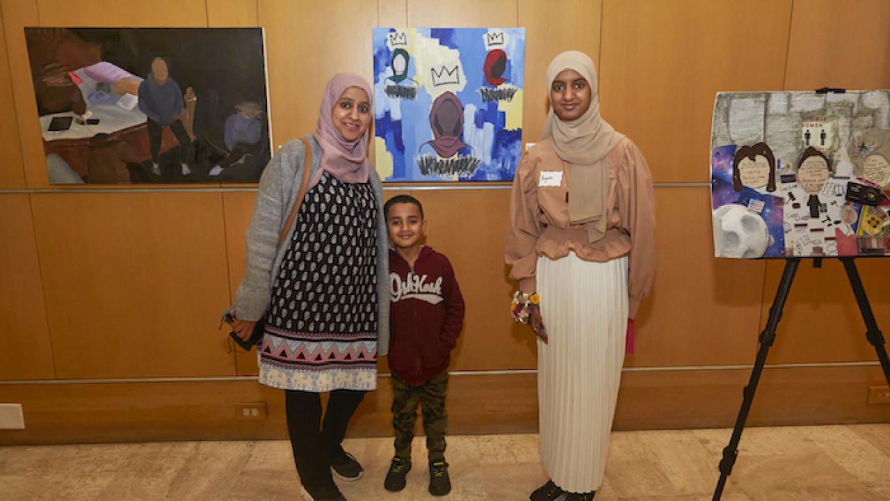 Family shown in art gallery.