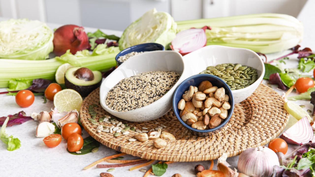 Closeup bowl chia seeds and other healthy foods on a kitchen table.
