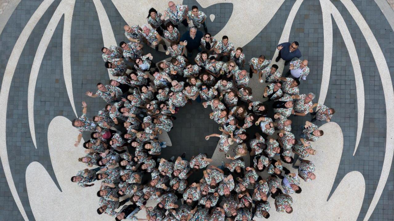 Aerial view of a group of people posed in a circle looking up